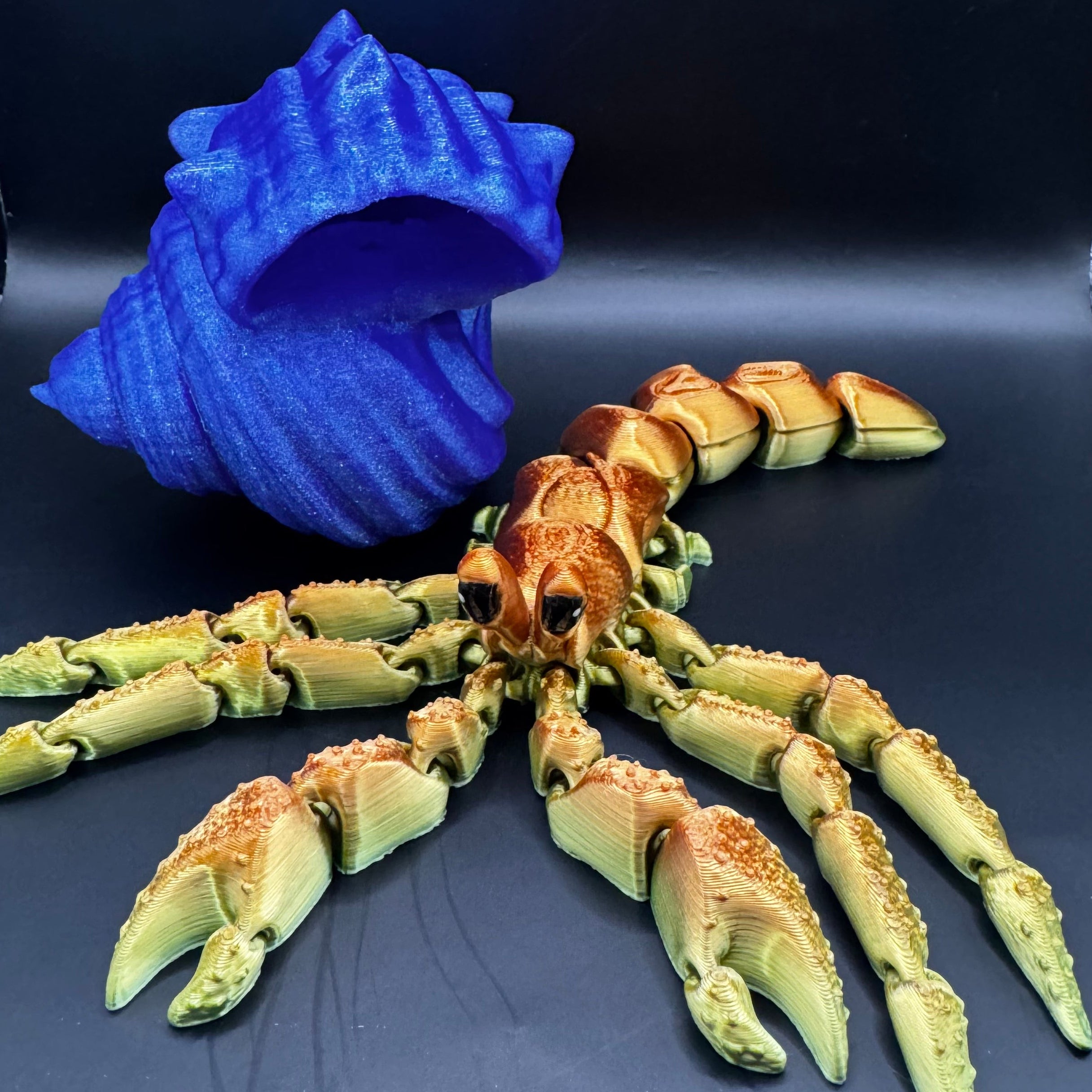 3d printed hermit crab with articulated body outside the blue shell 
