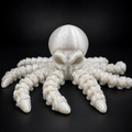 Ghost Current articulated glow-in-the-dark octopus companion in pearlescent white PLA with poseable tentacles on a black studio background.