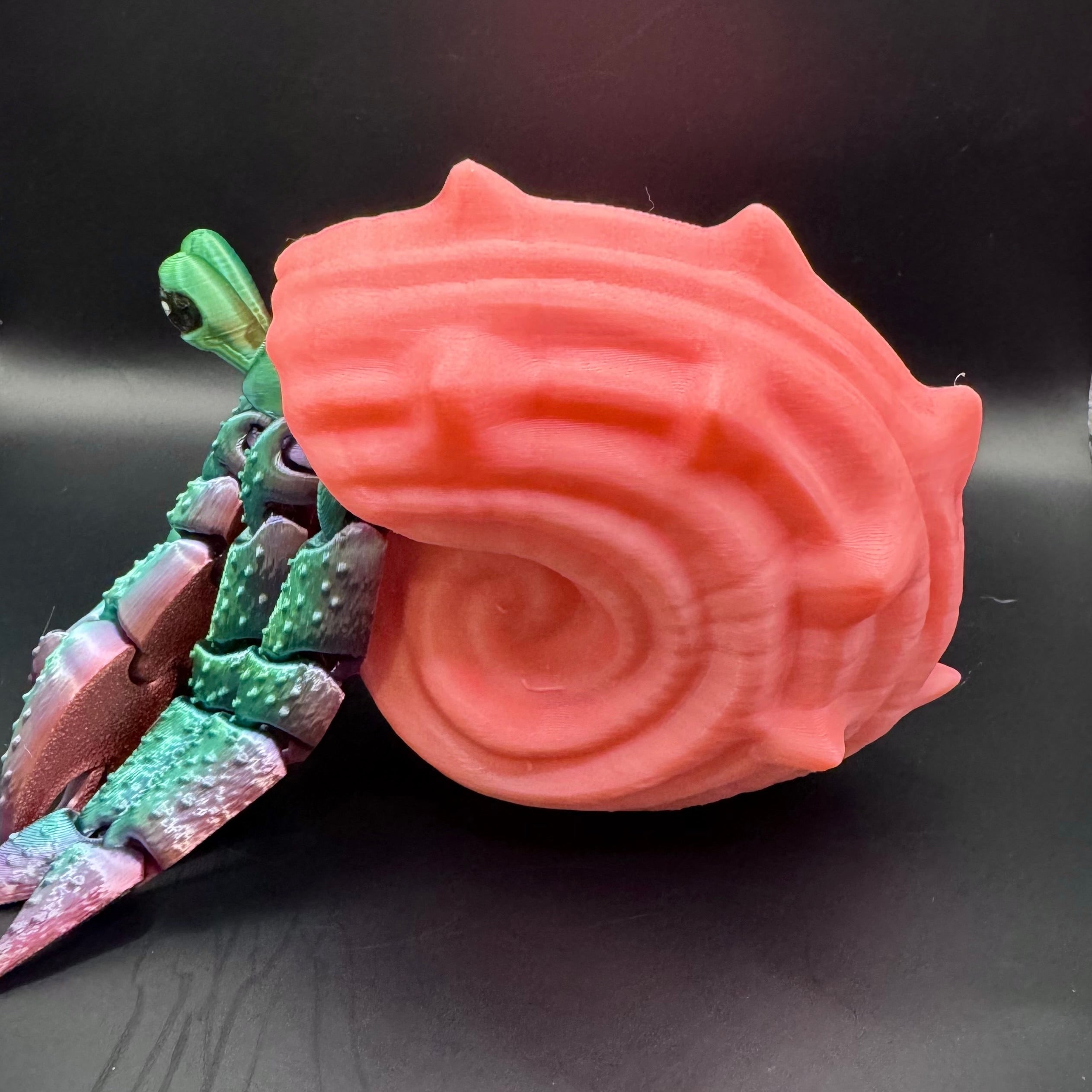 Green and purple ombre 3d printed hermit crab with pink shell 