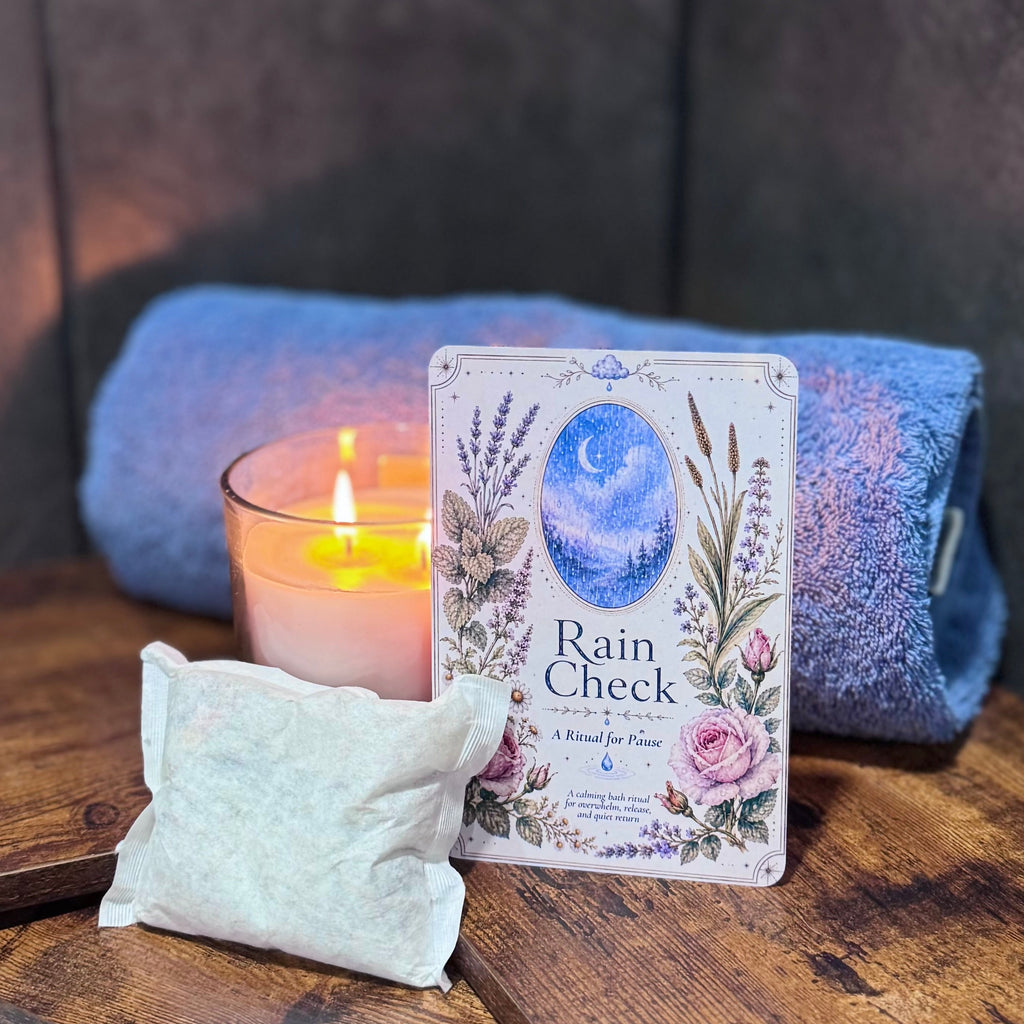 Candle, towel, and bath tea on a wooden surface with a dark background
