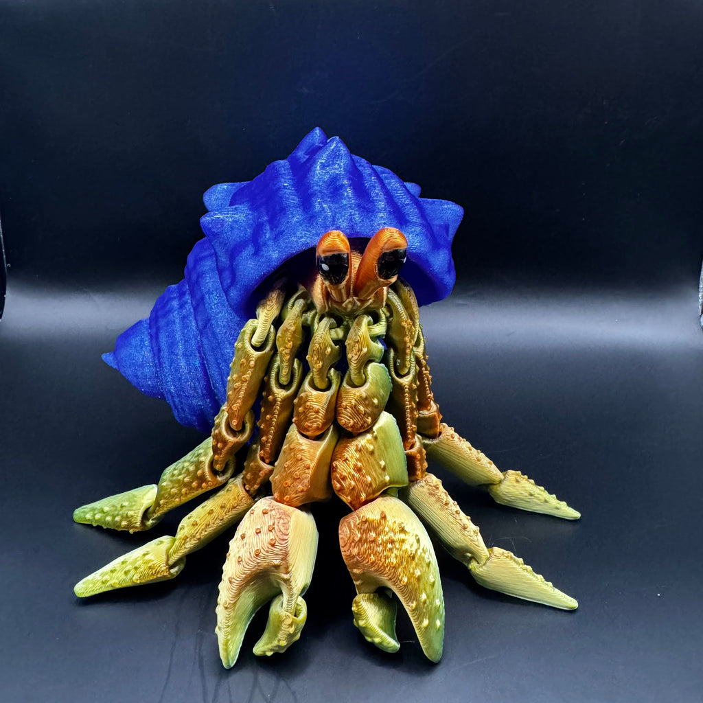 3d printed hermit crab with redish gold body inside a blue shell 