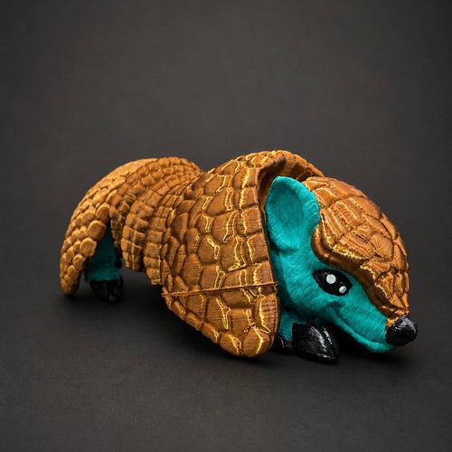 Burrow Bell articulated armadillo companion with a bronze shell and turquoise body on a dark background.