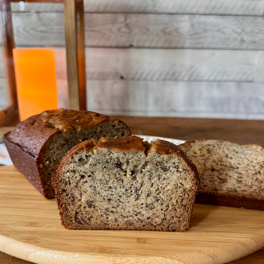 Classic banana bread loaf with thick slices cut to reveal its soft, moist crumb and banana-speckled interior.