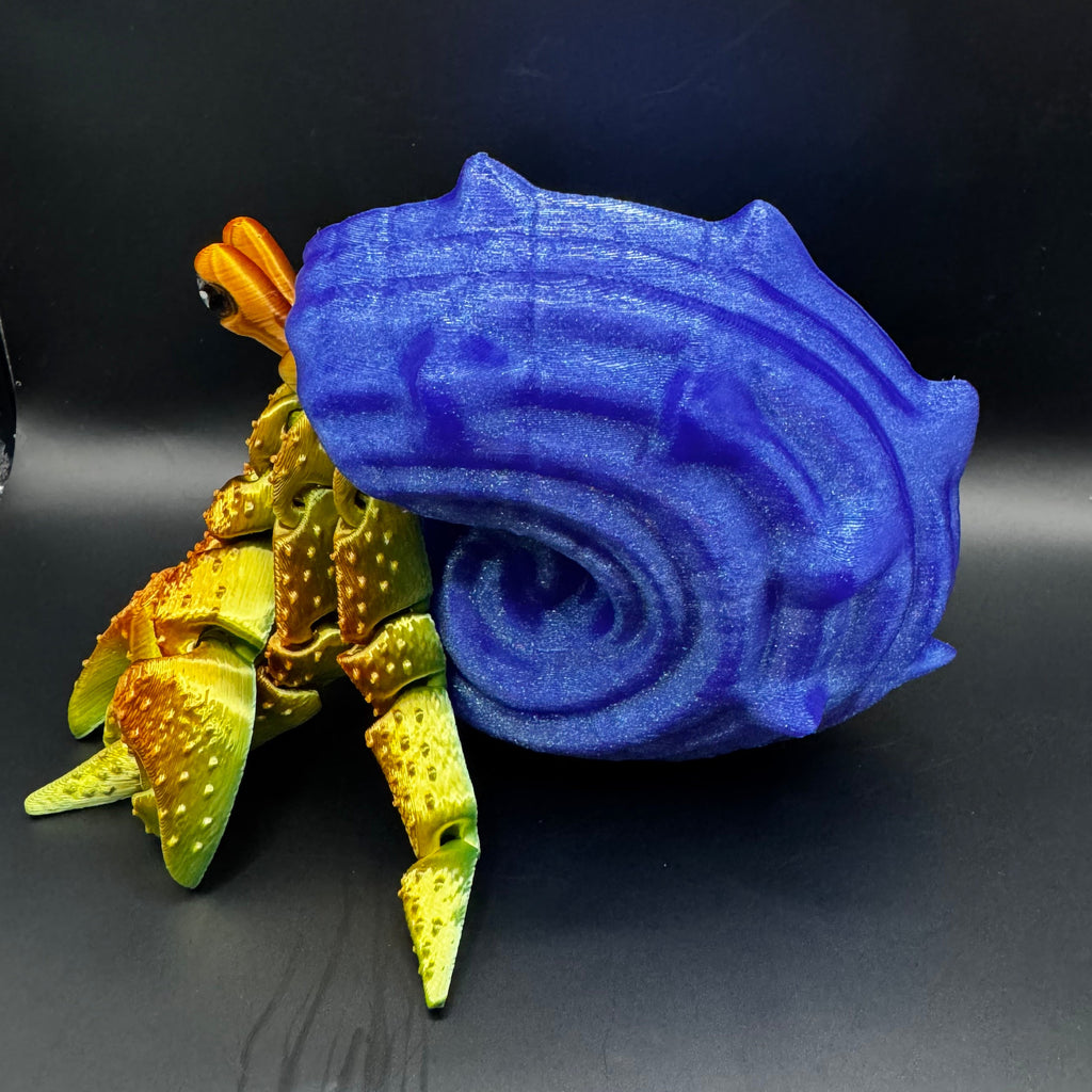 3d printed hermit crab with redish gold body inside a blue shell 