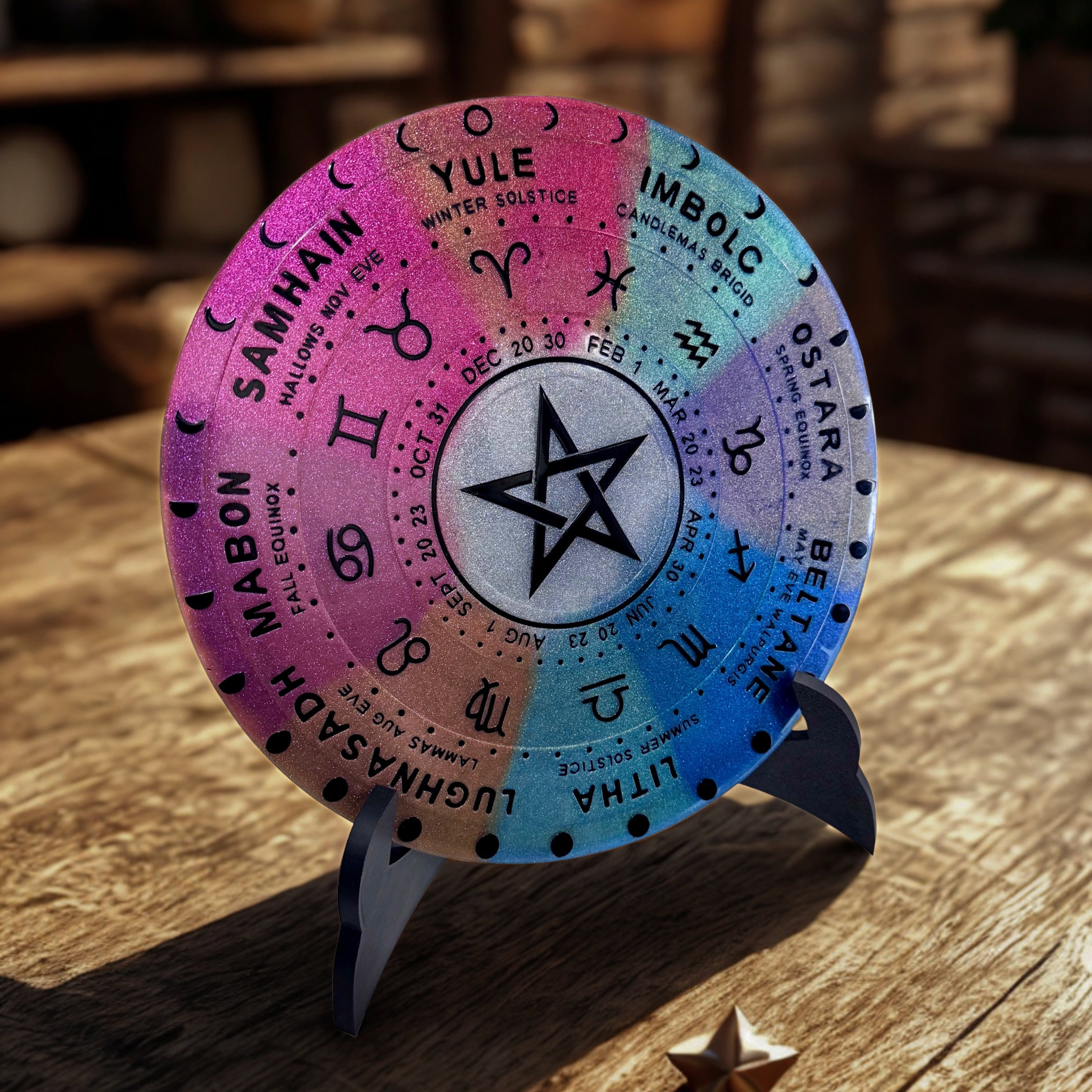 Colorful wheel of the year with star symbol on a wooden surface