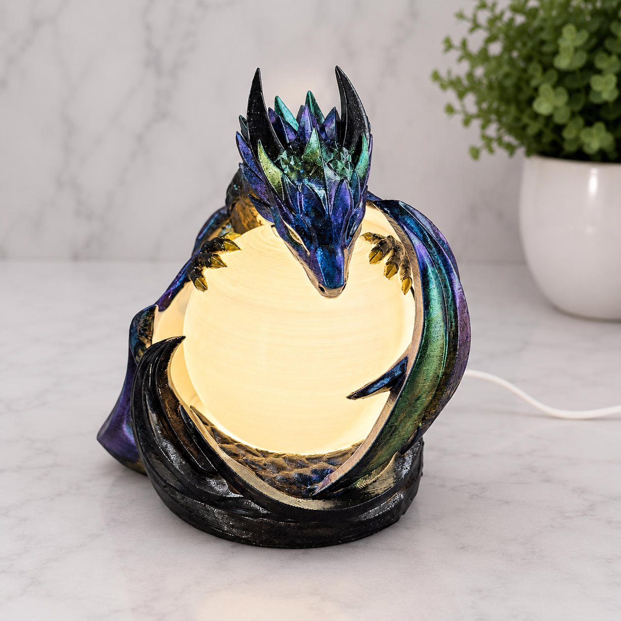 Front view of the illuminated Midnight Sentinel dragon lamp with warm white glowing orb and hand-painted metallic finish 