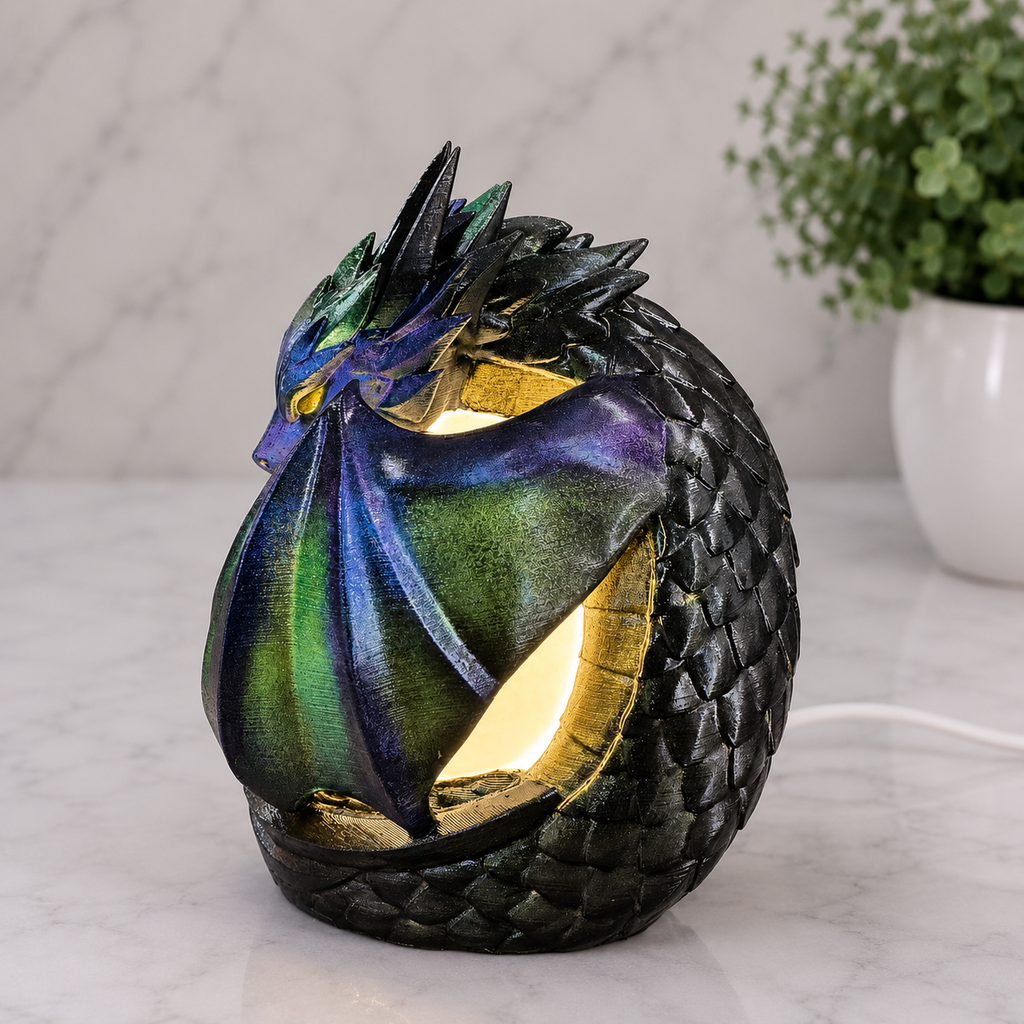 Illuminated left side view of midnight sentinel dragon lamp displaying shimmering blue, green,and violet wings