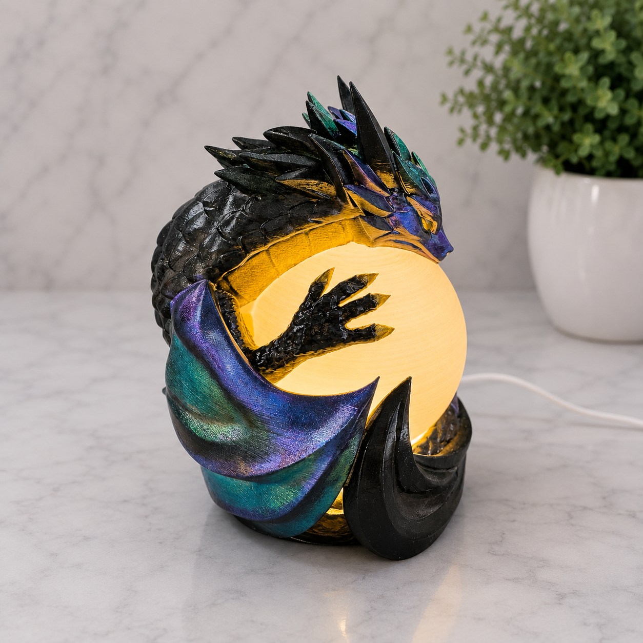 Illuminated three-quarter view of the Midnight Sentinel dragon lamp with color-shifting metallic wings and glowing orb