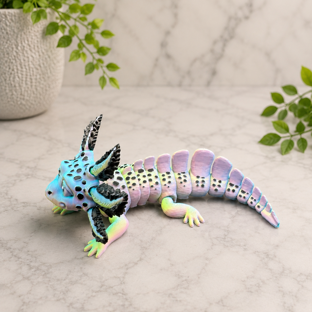 Left profile of the Opal Veil articulated axolotl displaying its segmented body, holographic filament, and wide decorative gills.