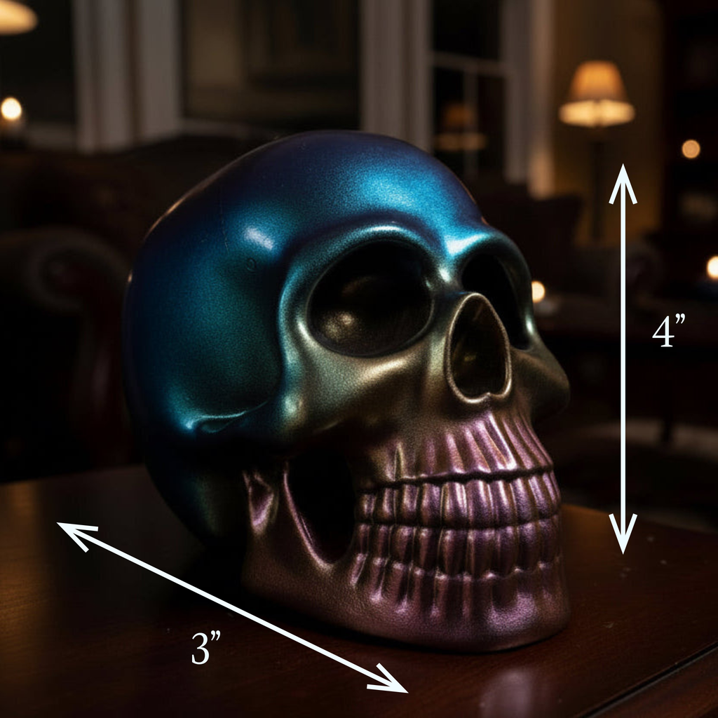 Color-shifting resin skull sculpture in rainbow, oil slick tones displayed on a table with measurements 