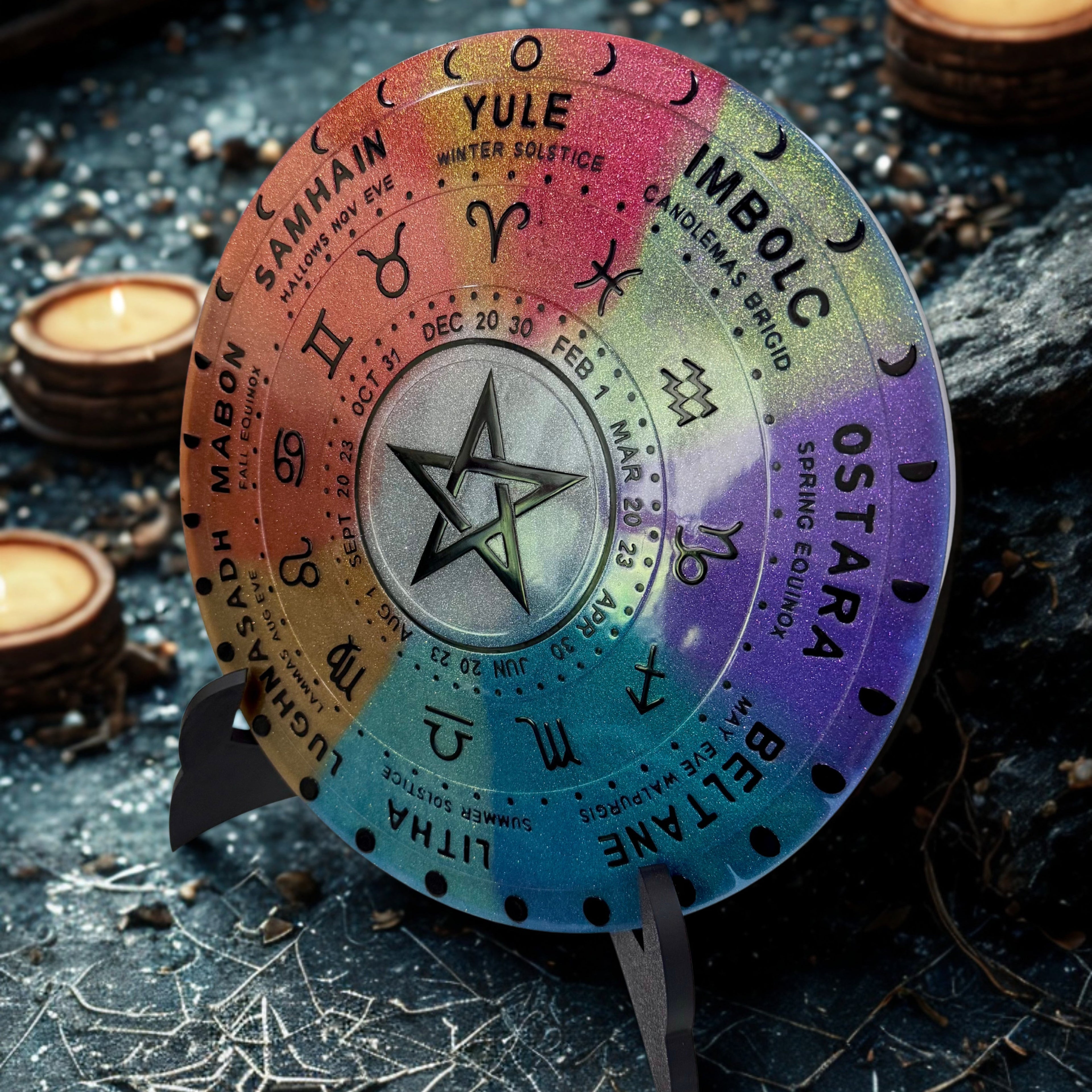 Colorful wheel of the year with astrological symbols on a dark background with candles.