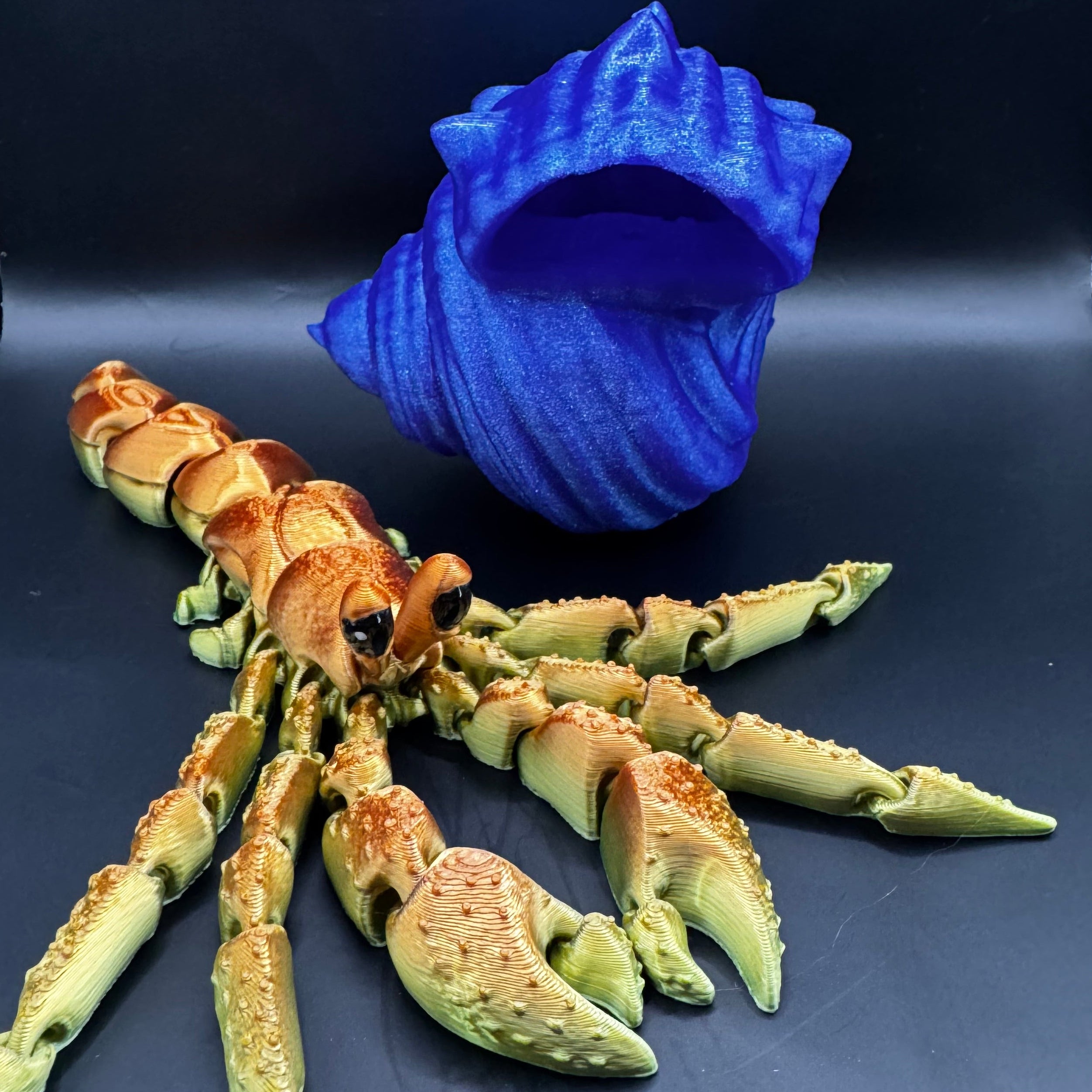 3d printed hermit crab with golden red body and blue shell 