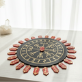 Red resin rune stones with gold inlays arranged in a circle around a black and red casting board with gold symbols
