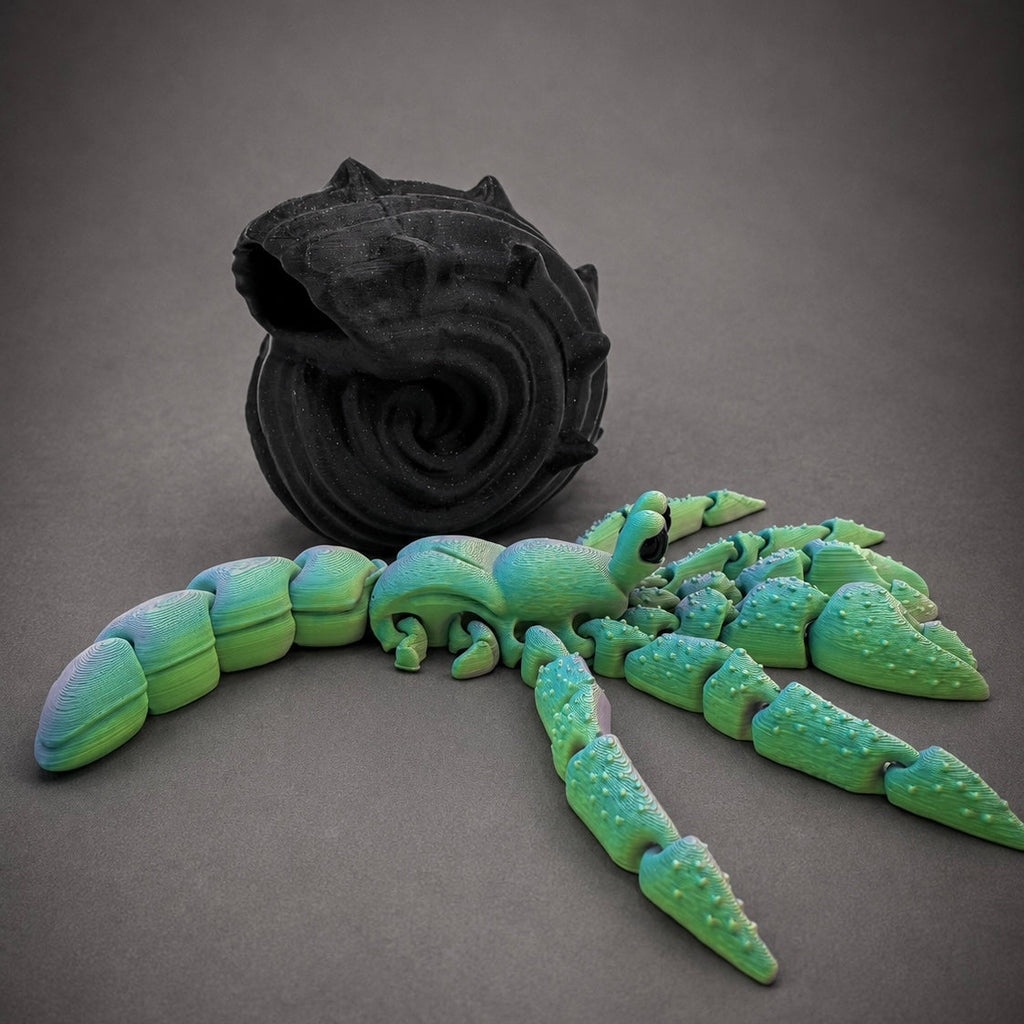 Sea Glass Hollow outside its shell showing the fluorite filament shifting toward vibrant greens and aquas beside the removable black shell.