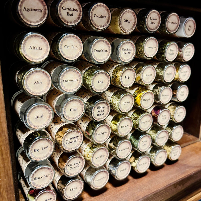 Collection of herb  jars with labels on a wooden shelf