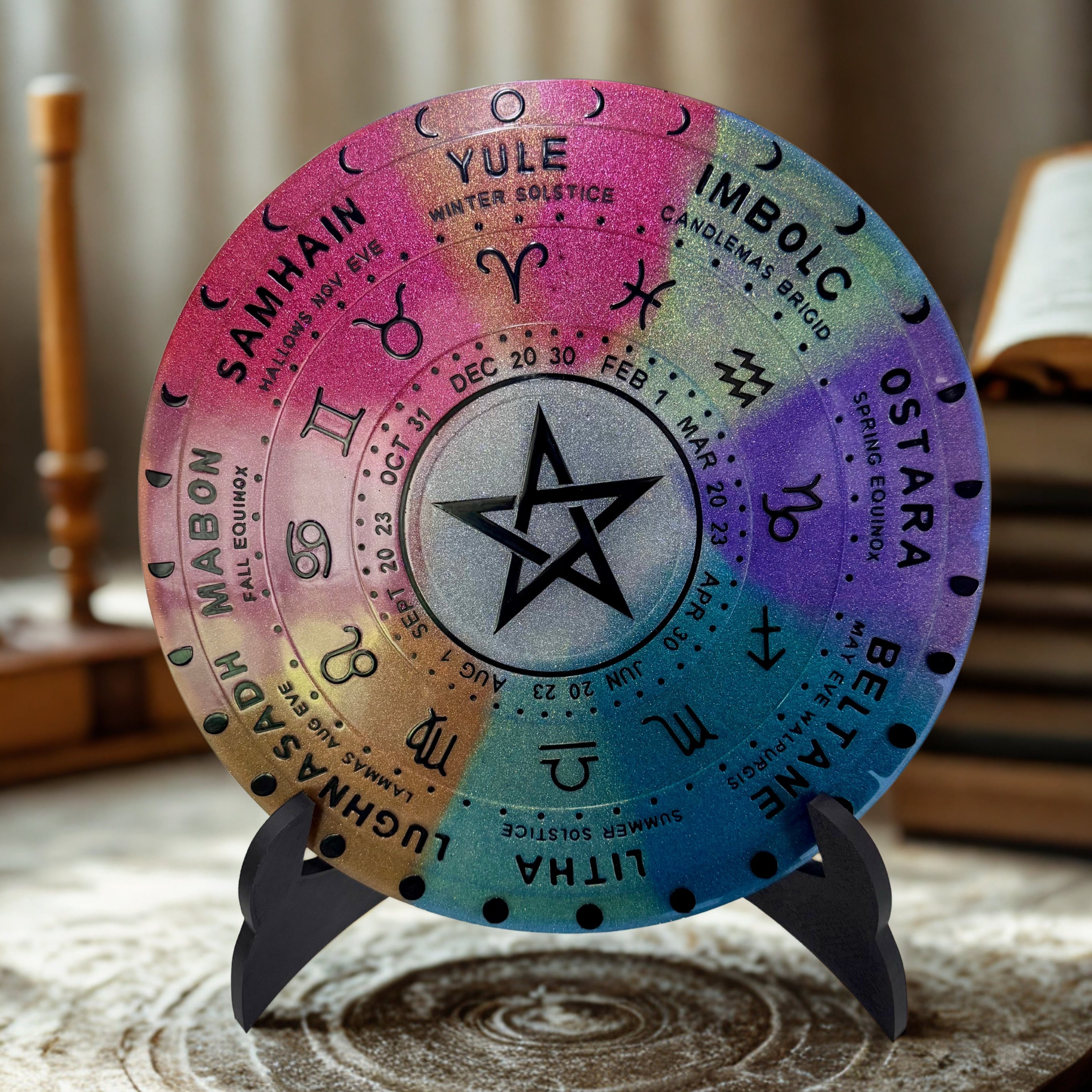 Colorful wheel of the year with astrological symbols on a stand.