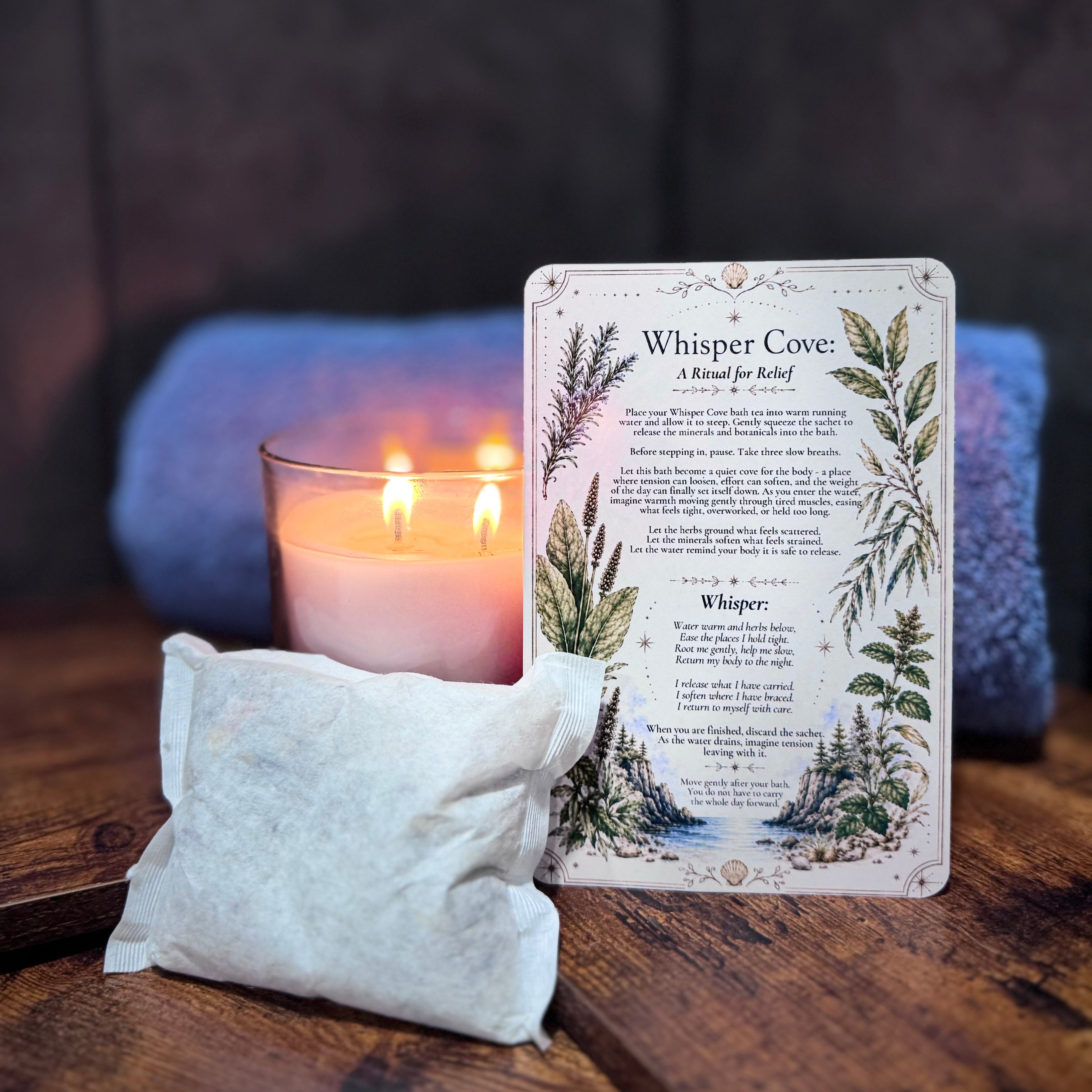 Whisper Cove bath tea with a candle and ritual card on a wooden surface